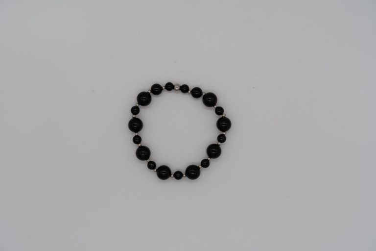 The Onyx Happy Crystal Bracelet is handcrafted with:
