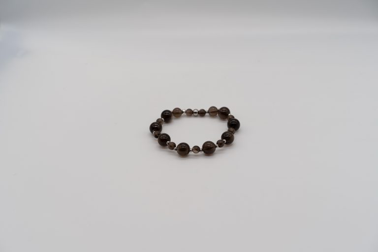 The Smokey Quartz Happy Crystal Bracelet is handcrafted with: